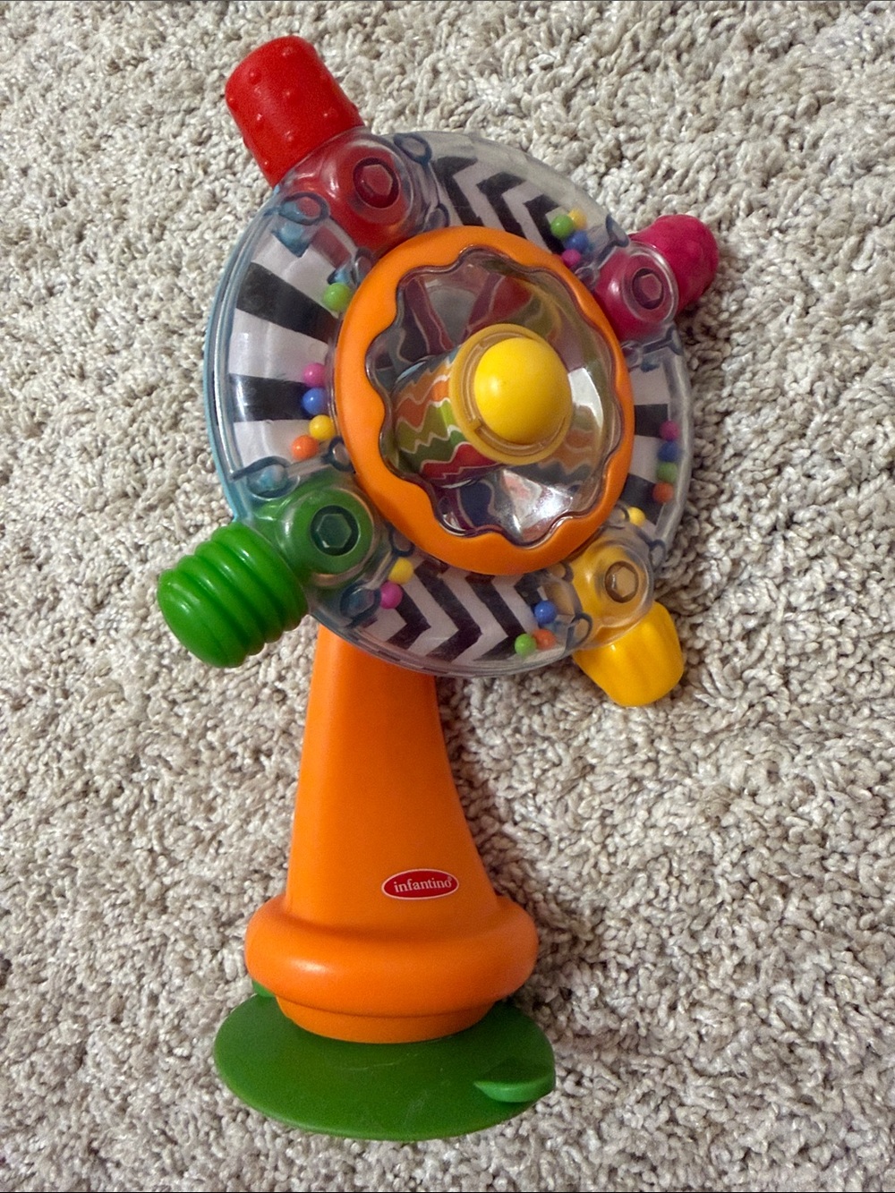 Infantino Orange Toy with Green, Yellow, Red, Pink, Blue Accents